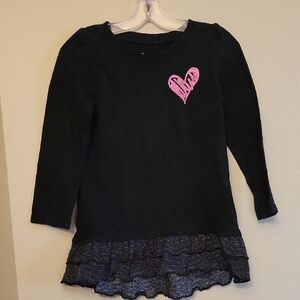 Black dress ruffle hem and pink heart detail